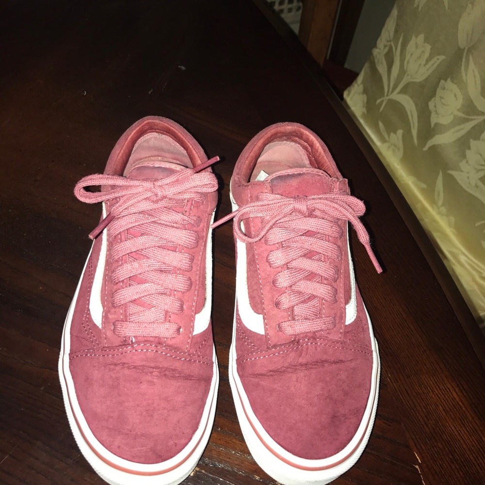 Burgundy Vans sneakers.